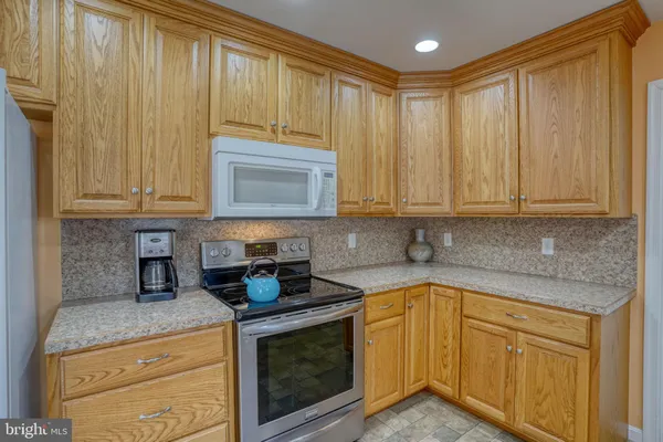 a kitchen with appliances cabinets and a counter top space