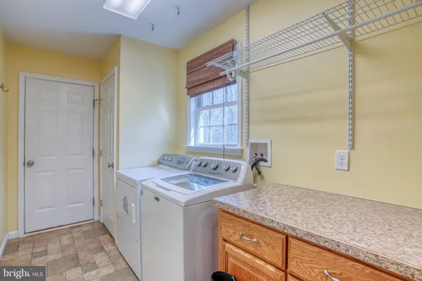 a utility room with cabinets washer and dryer