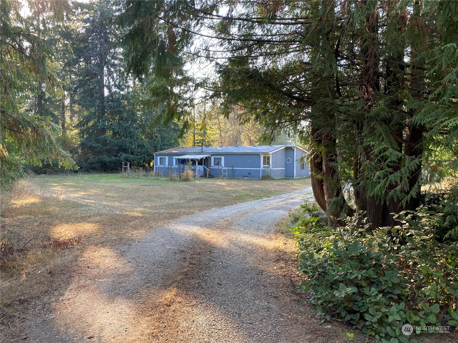 1425 East Victor Road Belfair, WA 98528 - Photo 1 of 19 a view of a house with yard and tree s