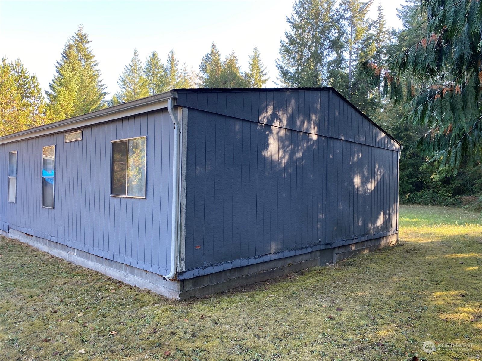 1425 East Victor Road Belfair, WA 98528 - Photo 3 of 19 a front view of a house with garden
