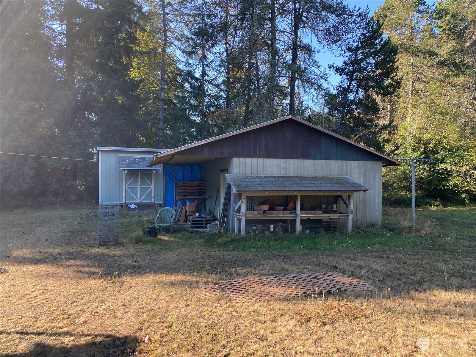 1425 East Victor Road Belfair, WA 98528 - Photo 5 of 19 a house with trees in front of it