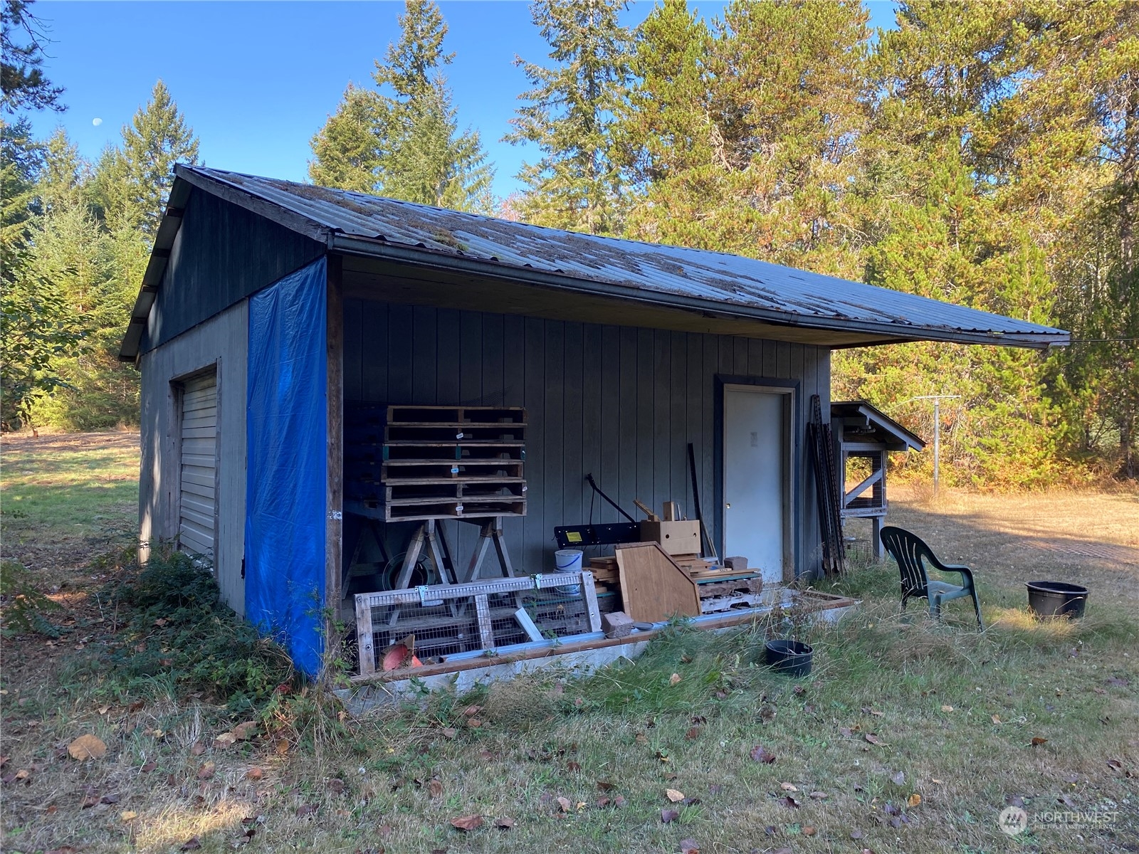 1425 East Victor Road Belfair, WA 98528 - Photo 6 of 19 a view of backyard with table and chairs and potted plants