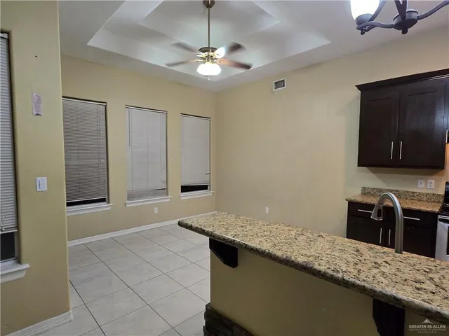 a kitchen with stainless steel appliances granite countertop a sink and a stove