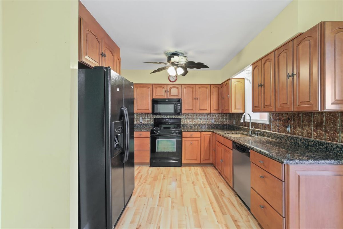1513 Gates Drive Rantoul, IL 61866 - Photo 14 of 37 a kitchen with stainless steel appliances granite countertop a refrigerator and a stove top oven