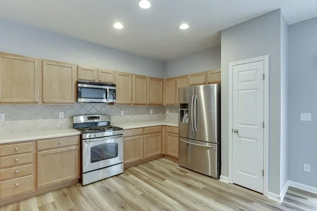 a kitchen with cabinets a sink and stainless steel appliances