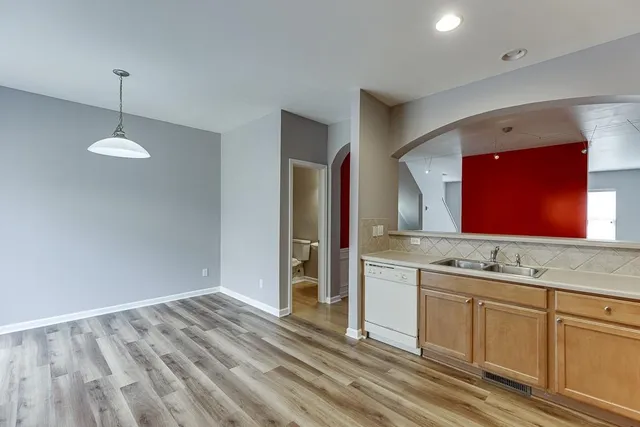 a metallic refrigerator freezer sitting in a kitchen