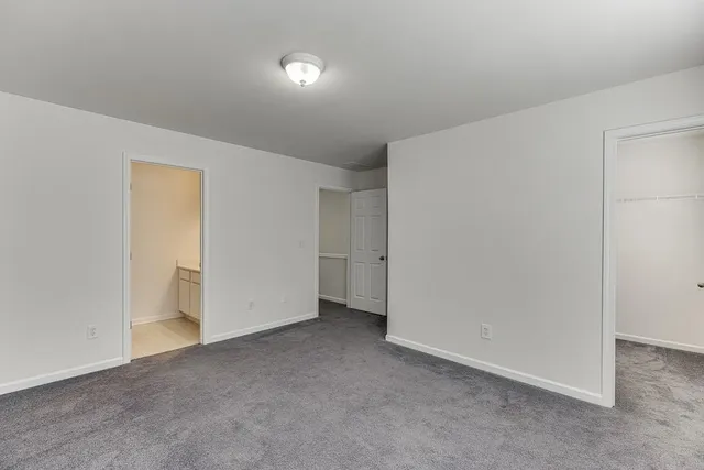 a bathroom with a sink vanity granite and toilet