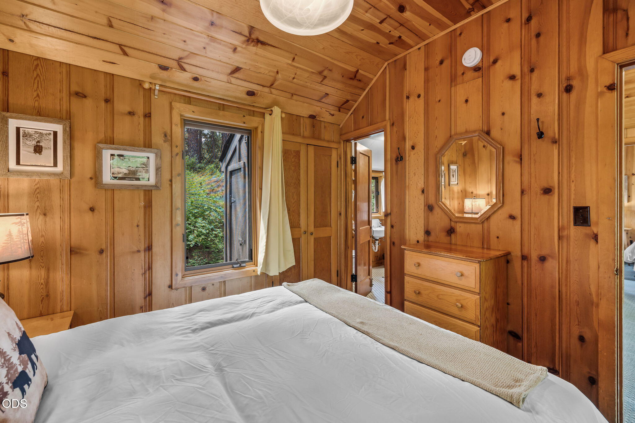 13375 Southwest Forest Service Road, Unit 3 U1 Camp Sherman, OR 97730 - Photo 23 of 29 a bedroom with a large bed and a chandelier