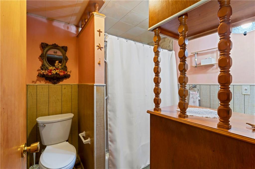 890 Deer Lane Rochester, PA 15074 - Photo 8 of 22 a bathroom with a toilet and a shower curtain
