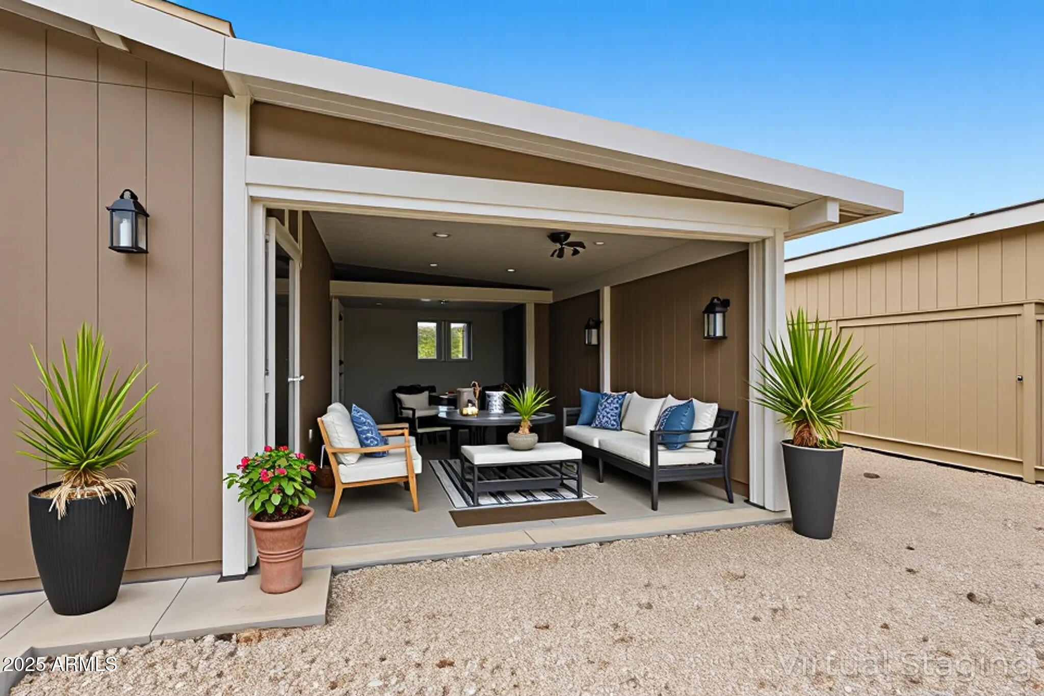 8865 East Baseline Road, Unit 130 Mesa, AZ 85209 - Photo 5 of 48 a view of a patio with potted plants and a table and chair