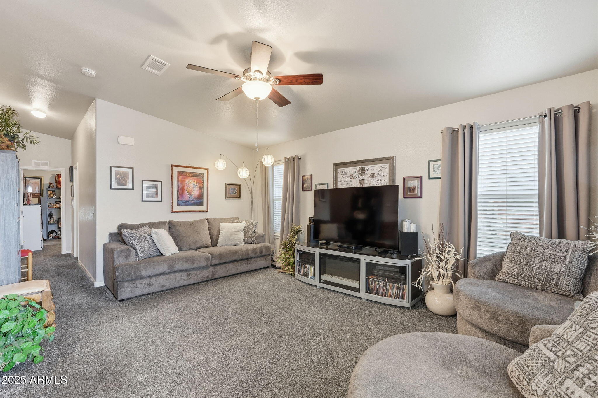 8865 East Baseline Road, Unit 130 Mesa, AZ 85209 - Photo 6 of 48 a living room with furniture and a flat screen tv