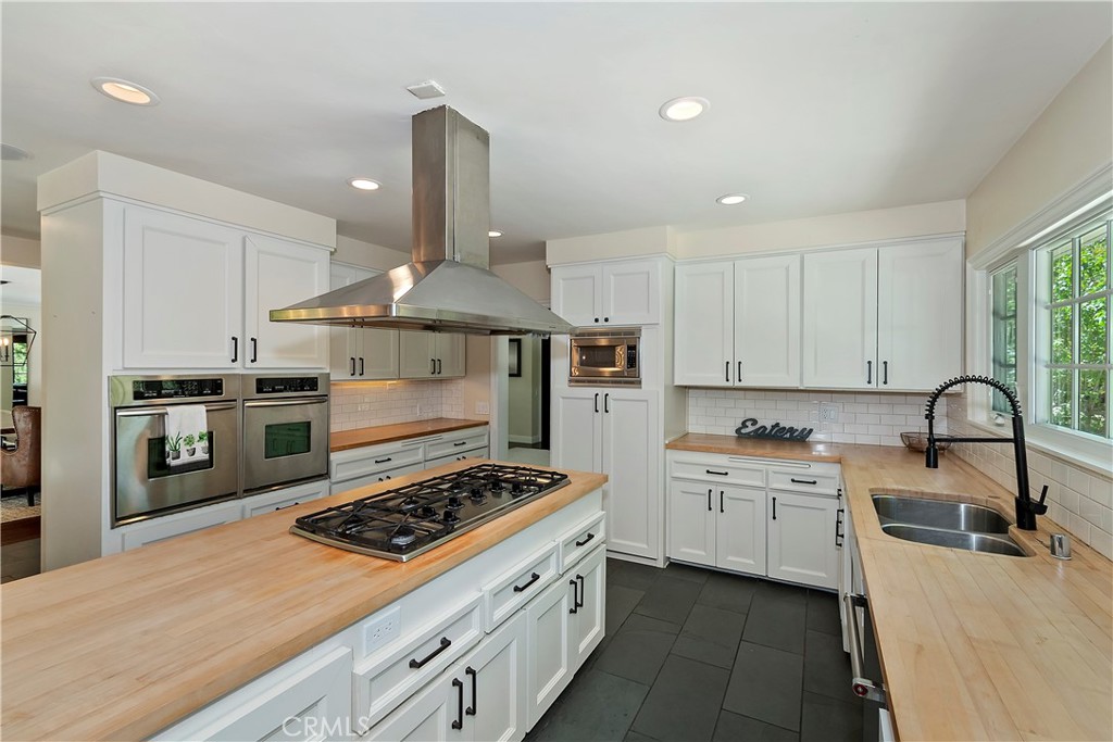 28411 North Shore Road Lake Arrowhead, CA 92352 - Photo 19 of 66 a kitchen with a stove a sink dishwasher and a refrigerator with wooden floor