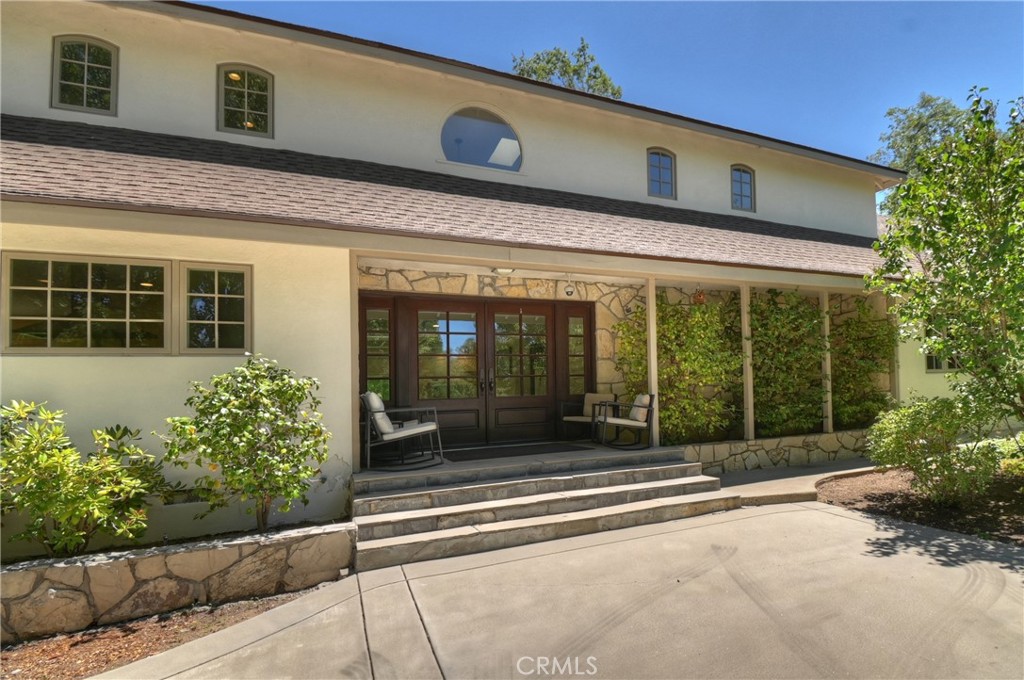 28411 North Shore Road Lake Arrowhead, CA 92352 - Photo 20 of 66 a view of a house with a potted plant and a large window