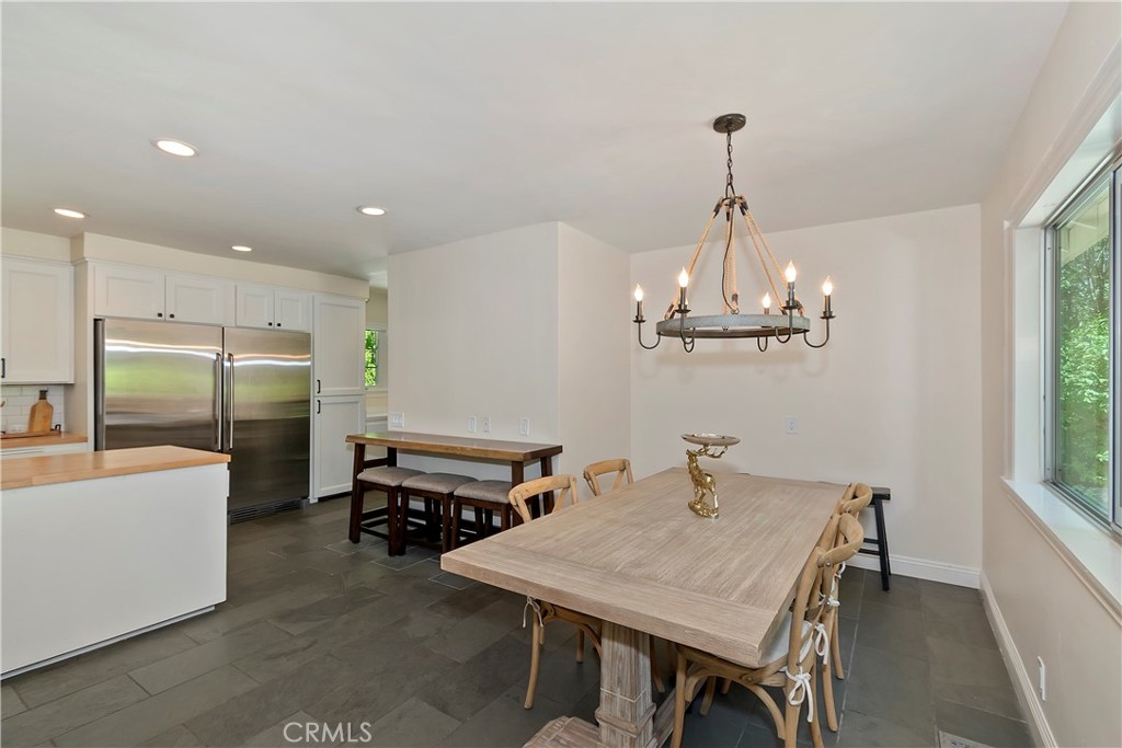 28411 North Shore Road Lake Arrowhead, CA 92352 - Photo 22 of 66 a room with a table chairs and a chandelier