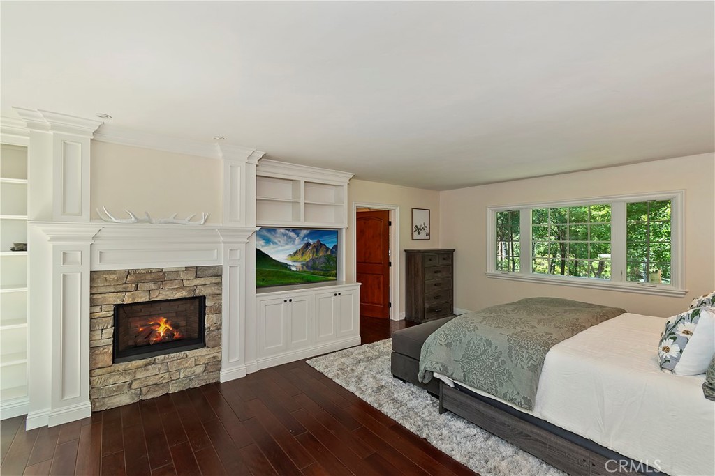 28411 North Shore Road Lake Arrowhead, CA 92352 - Photo 24 of 66 a spacious bedroom with a bed and a fireplace