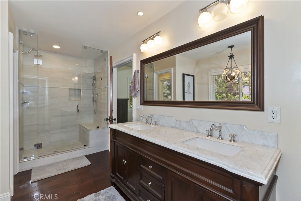 28411 North Shore Road Lake Arrowhead, CA 92352 - Photo 29 of 66 a bathroom with a granite countertop sink mirror and shower