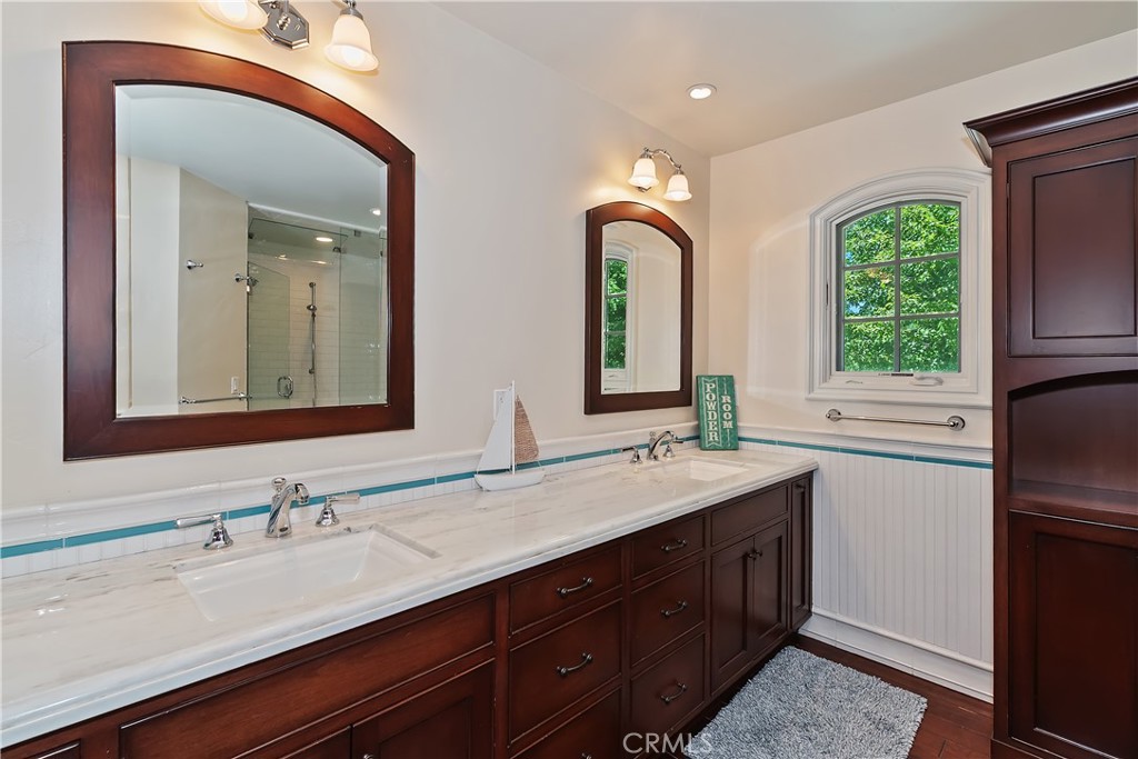 28411 North Shore Road Lake Arrowhead, CA 92352 - Photo 36 of 66 a bathroom with a double vanity sink and a mirror
