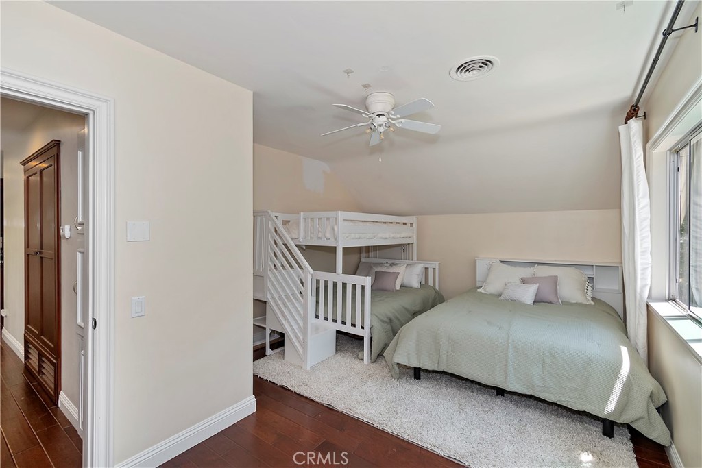 28411 North Shore Road Lake Arrowhead, CA 92352 - Photo 38 of 66 a bedroom with a bed and a chandelier