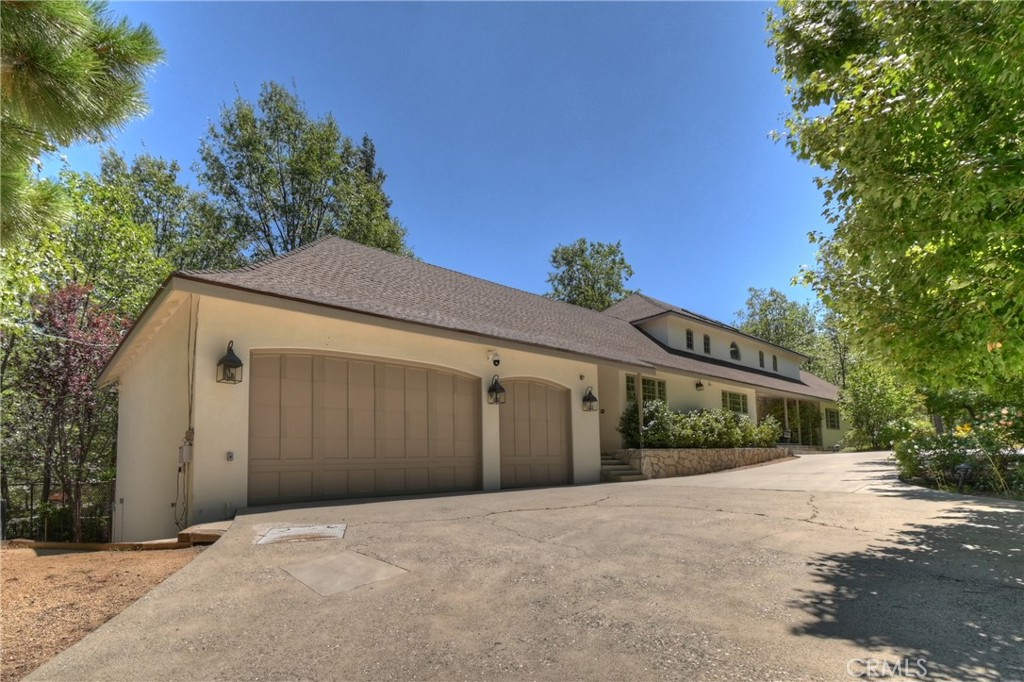 28411 North Shore Road Lake Arrowhead, CA 92352 - Photo 62 of 66 a front view of a house with a yard and garage