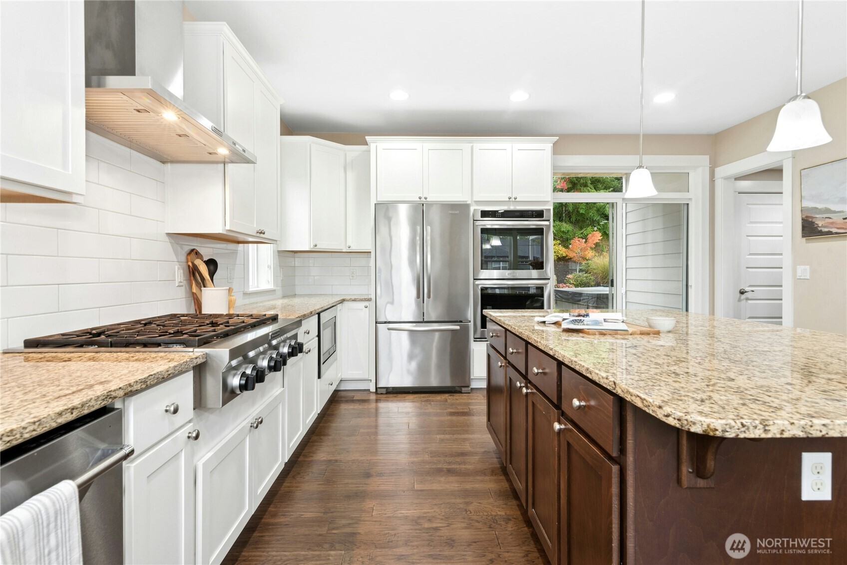 14713 98th Avenue Northeast Bothell, WA 98011 - Photo 12 of 40 a kitchen with stainless steel appliances granite countertop a stove a sink and a refrigerator