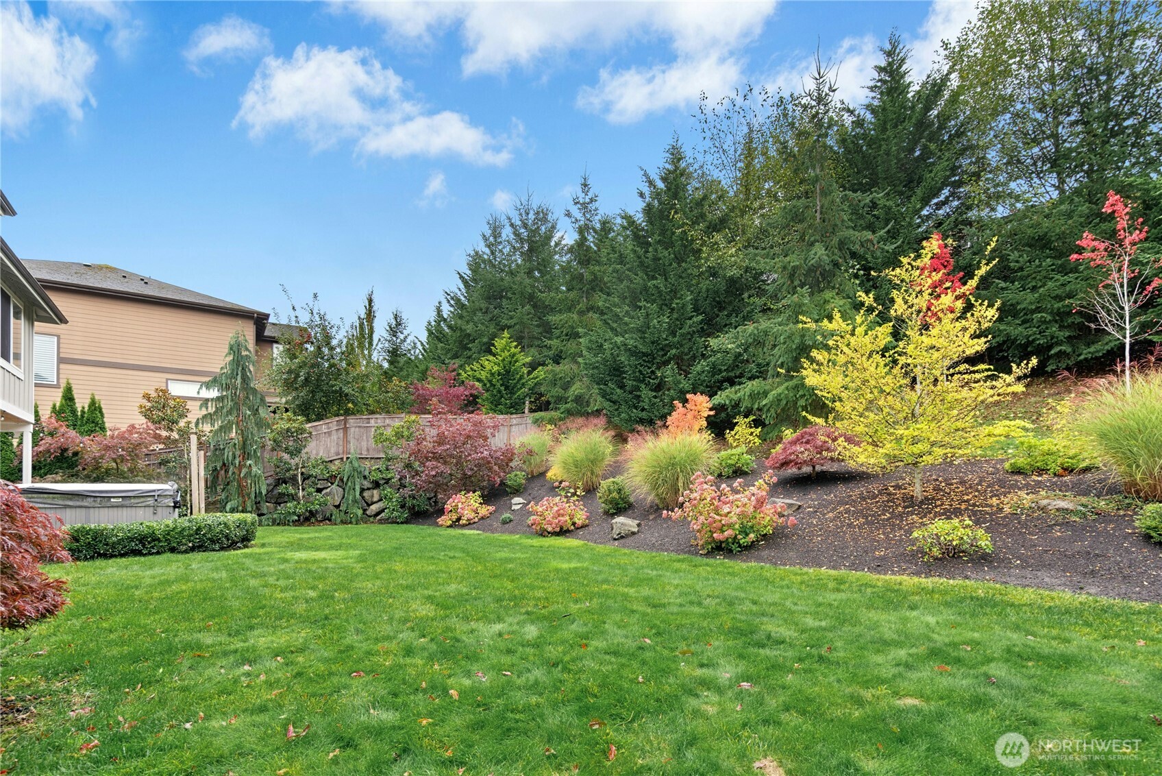 14713 98th Avenue Northeast Bothell, WA 98011 - Photo 34 of 40 a view of a backyard with potted plants and large trees