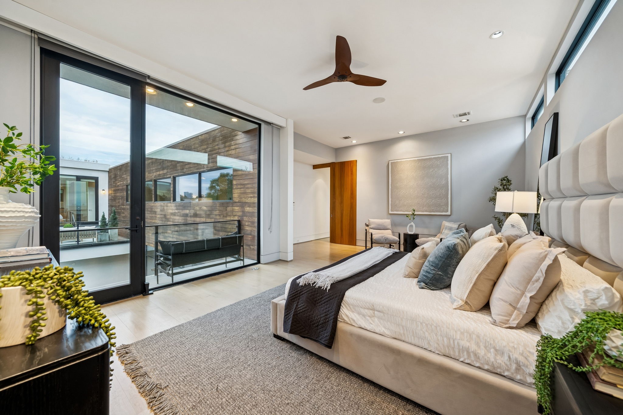 2332 Wroxton Road Houston, TX 77005 - Photo 29 of 50 a spacious bedroom with a bed and a chandelier