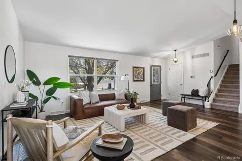 a living room with furniture and a potted plant