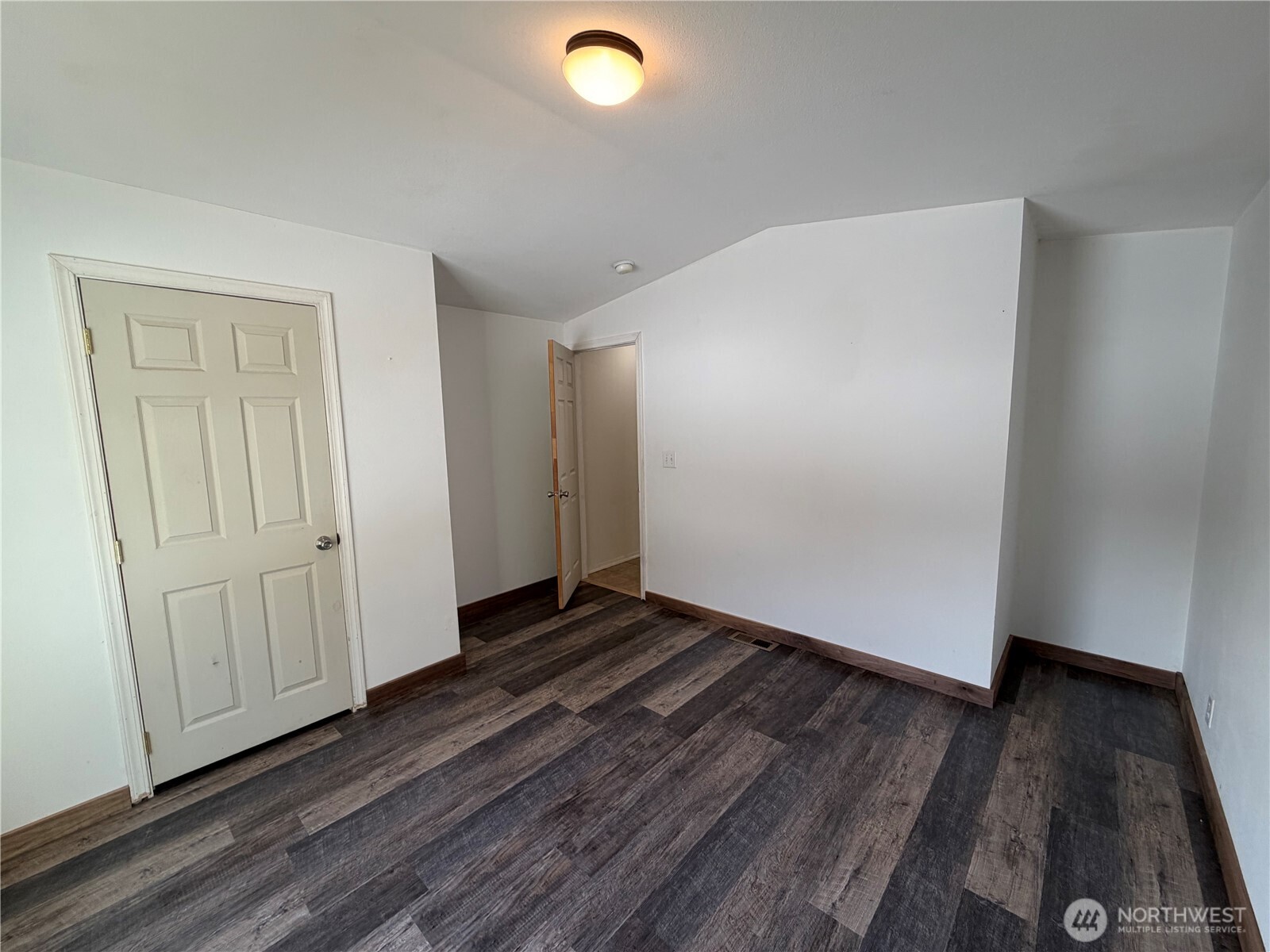 87 Canyon Creek Road Oroville, WA 98844 - Photo 11 of 24 a view of an empty room with wooden floor