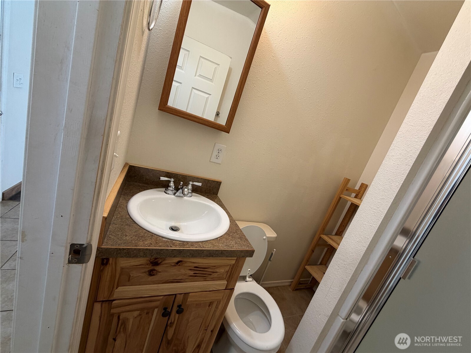 87 Canyon Creek Road Oroville, WA 98844 - Photo 13 of 24 a bathroom with a sink a toilet and a mirror