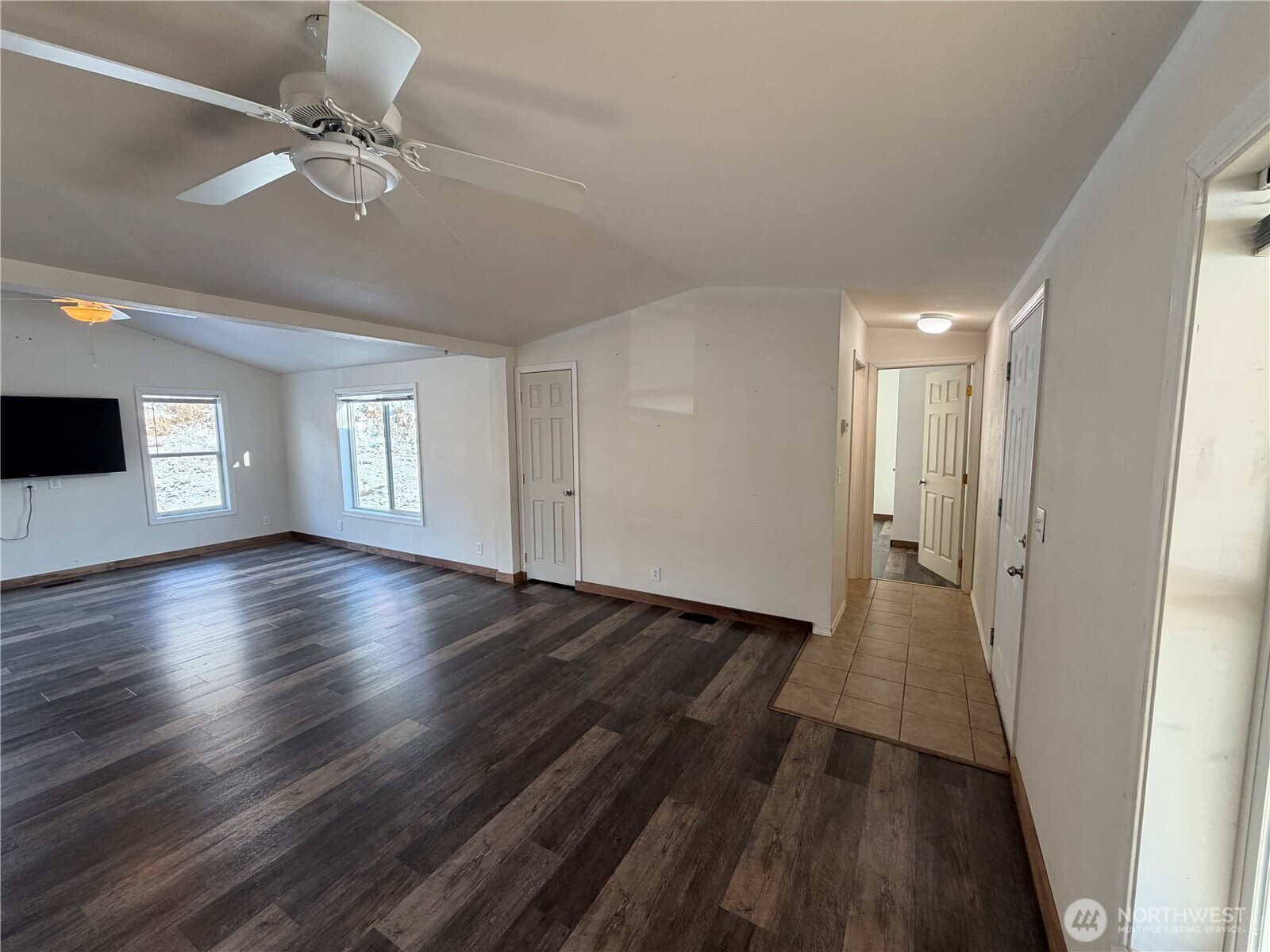 87 Canyon Creek Road Oroville, WA 98844 - Photo 5 of 24 a view of an empty room with a window and wooden floor