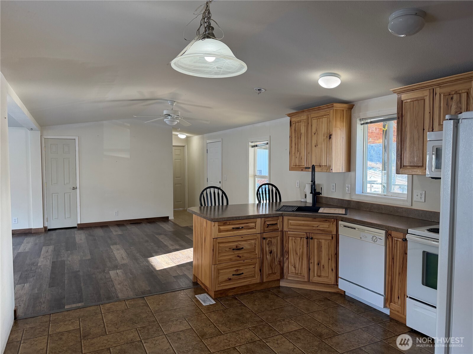 87 Canyon Creek Road Oroville, WA 98844 - Photo 8 of 24 a kitchen with stainless steel appliances granite countertop a sink and cabinets