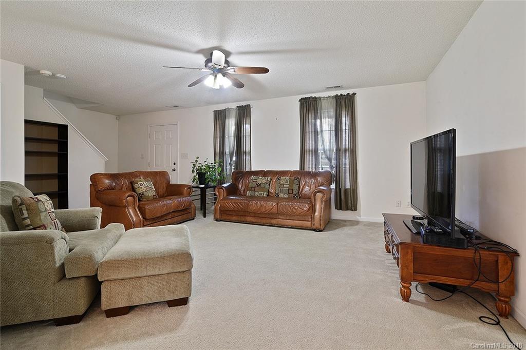 3109 Rockingham Court Southwest Concord, NC 28025 - Photo 3 of 15 a living room with furniture and a flat screen tv