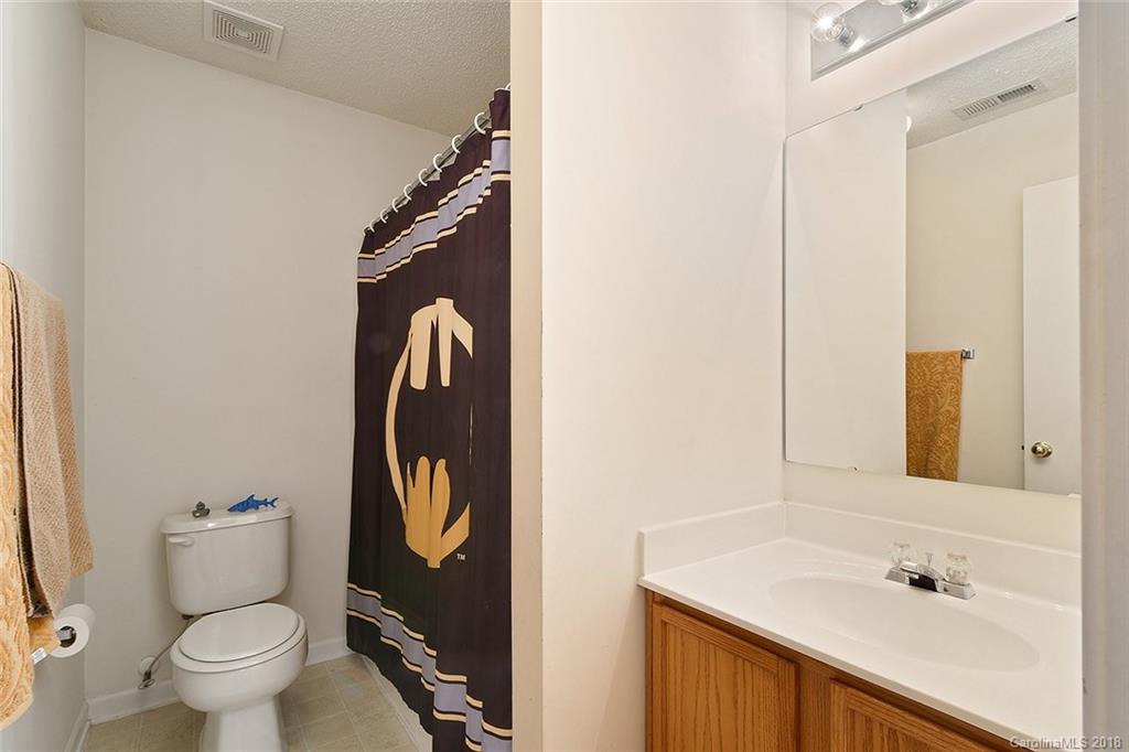 3109 Rockingham Court Southwest Concord, NC 28025 - Photo 8 of 15 a bathroom with a toilet sink and mirror
