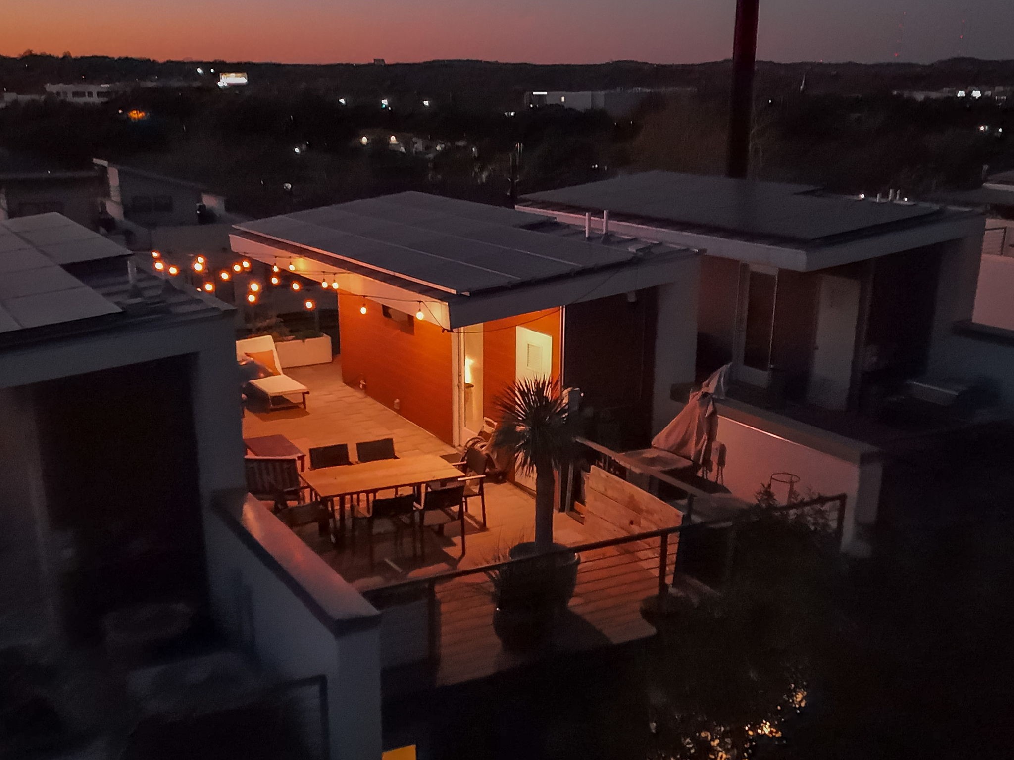 2301 South 5th Street, Unit 5 Austin, TX 78704 - Photo 34 of 39 Back of rooftop patio area for entertaining at dusk featuring solar panels