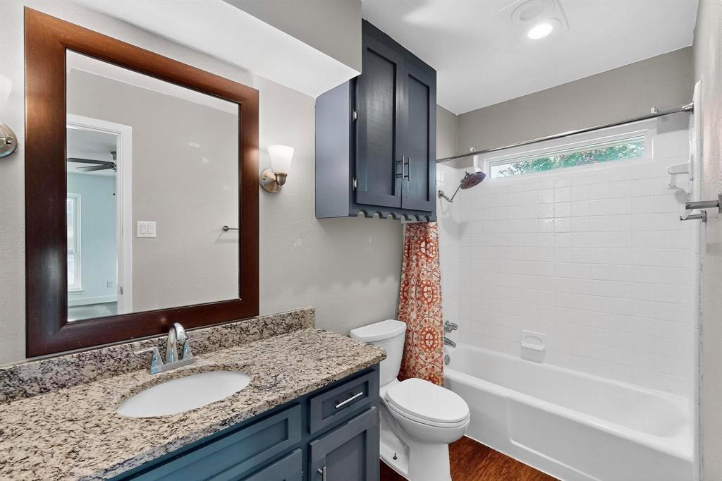 4857 Fallon Place Dallas, TX 75227 - Photo 12 of 19 Bathroom with shower / bath combo with shower curtain, vanity, and dark wood-style flooring