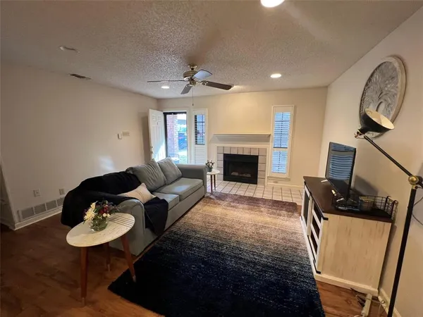 a living room with furniture a flat screen tv and a rug