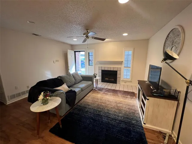 a living room with furniture a flat screen tv and a rug
