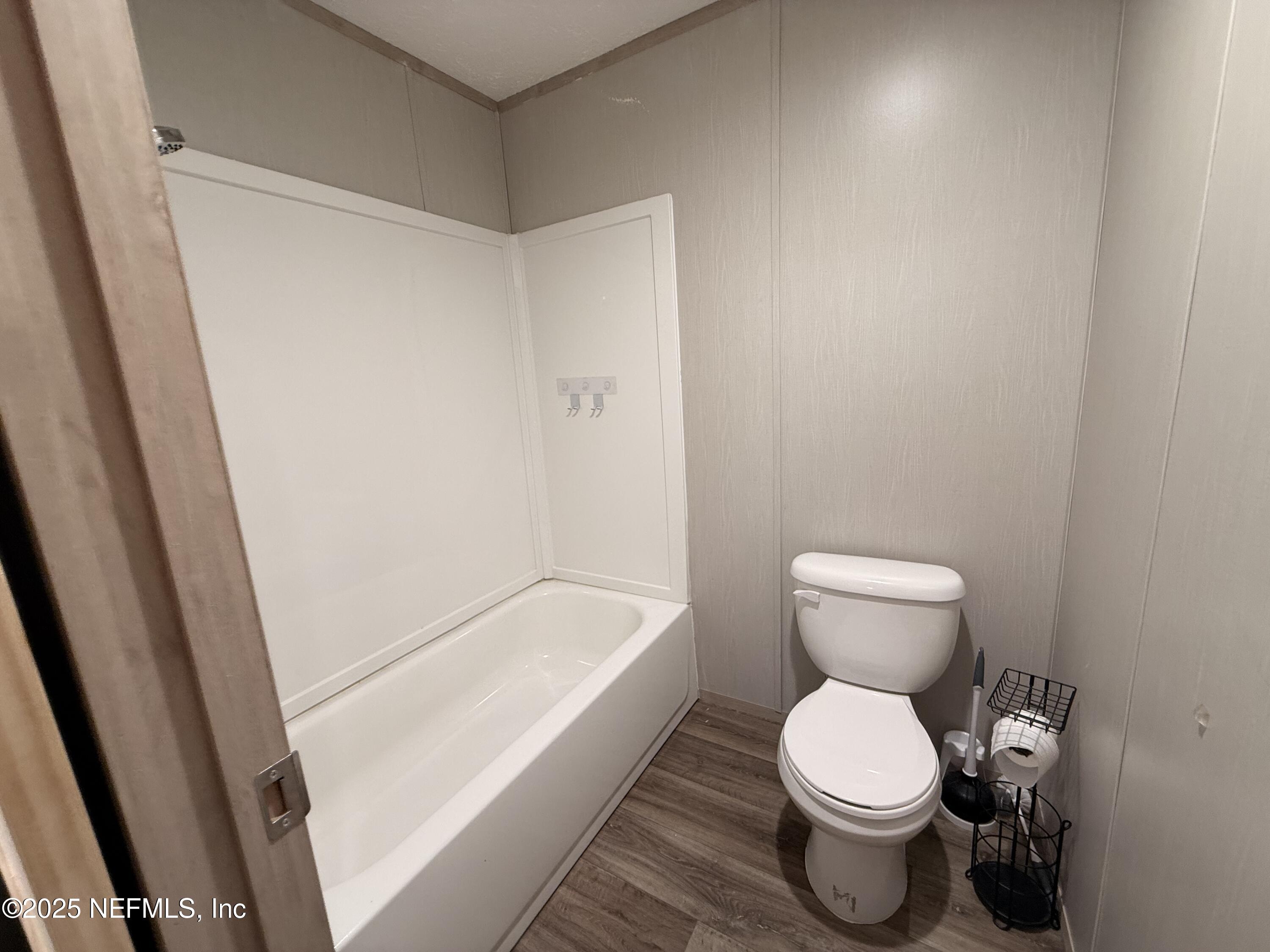 2355 Walters Road Middleburg, FL 32068 - Photo 22 of 63 a white toilet sitting next to a white sink and vanity