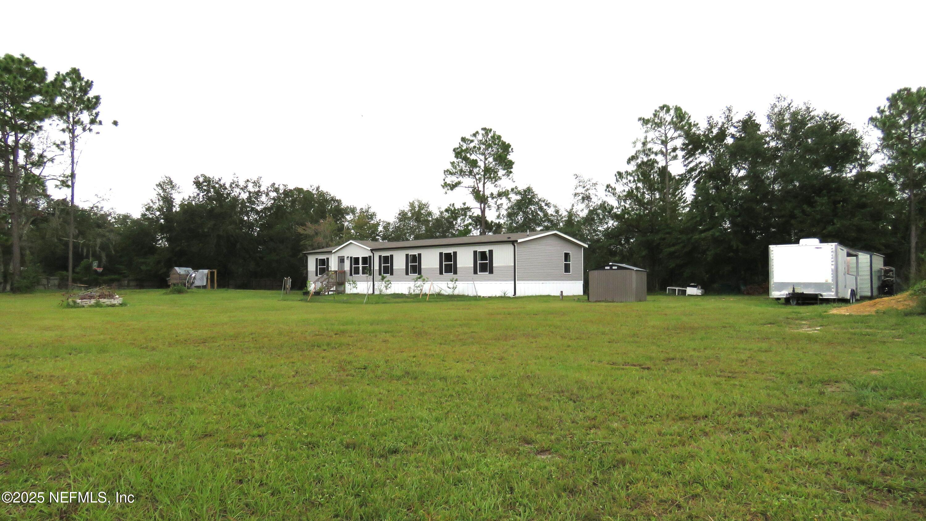 2355 Walters Road Middleburg, FL 32068 - Photo 31 of 63 a front view of a house with a garden