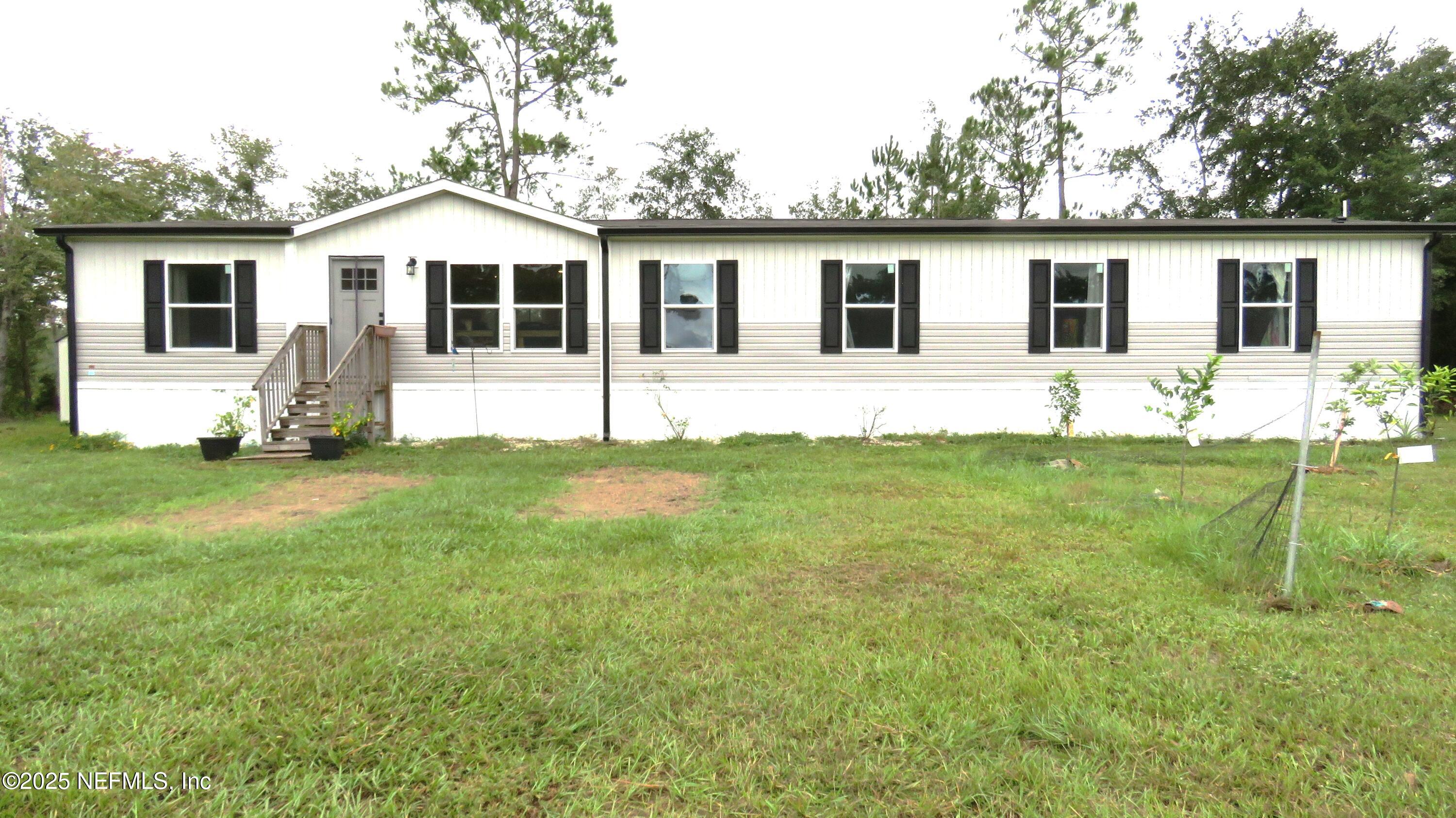 2355 Walters Road Middleburg, FL 32068 - Photo 51 of 63 a front view of a house with a yard and porch