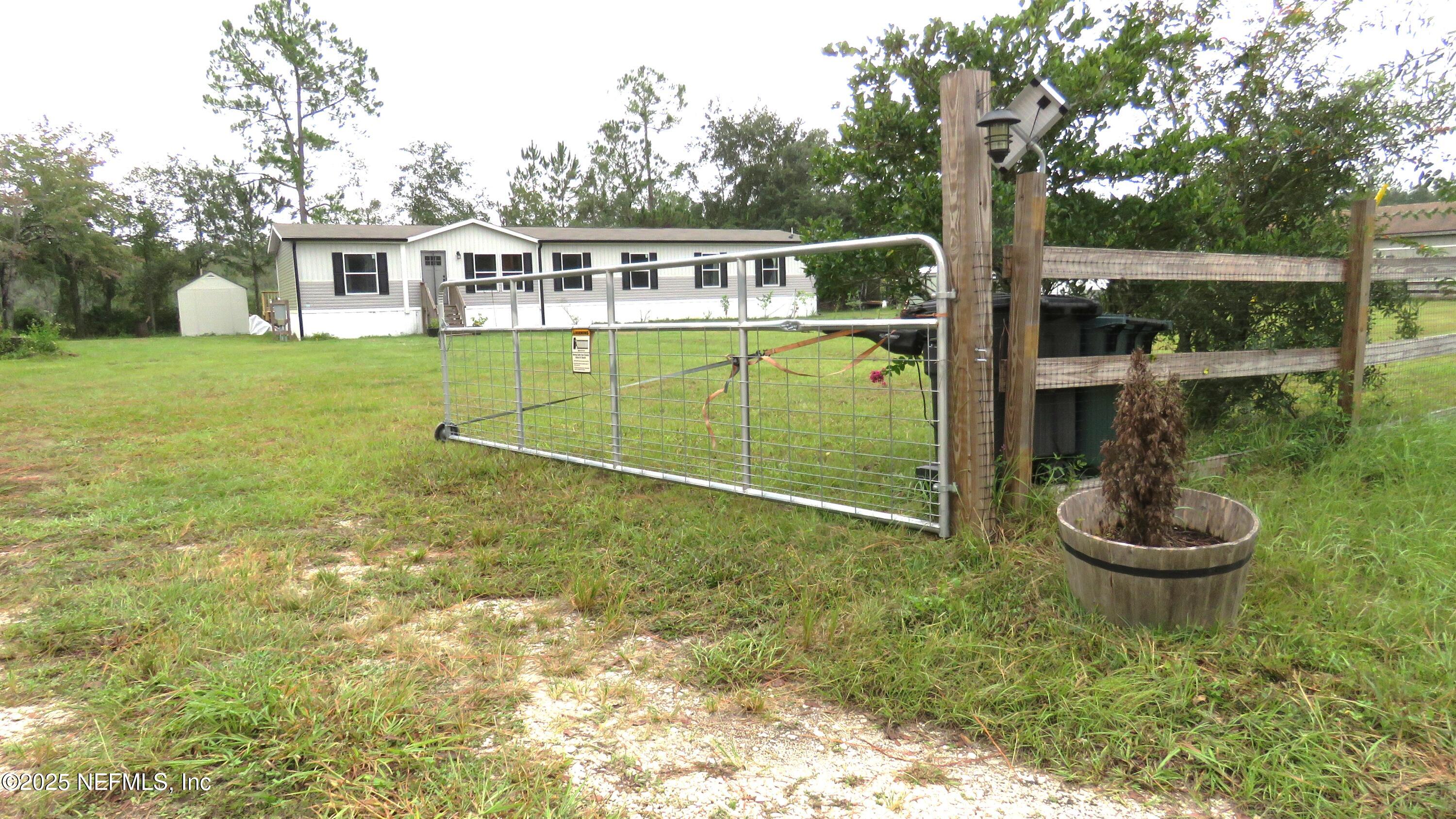 2355 Walters Road Middleburg, FL 32068 - Photo 56 of 63 a view of a house with a backyard and a patio