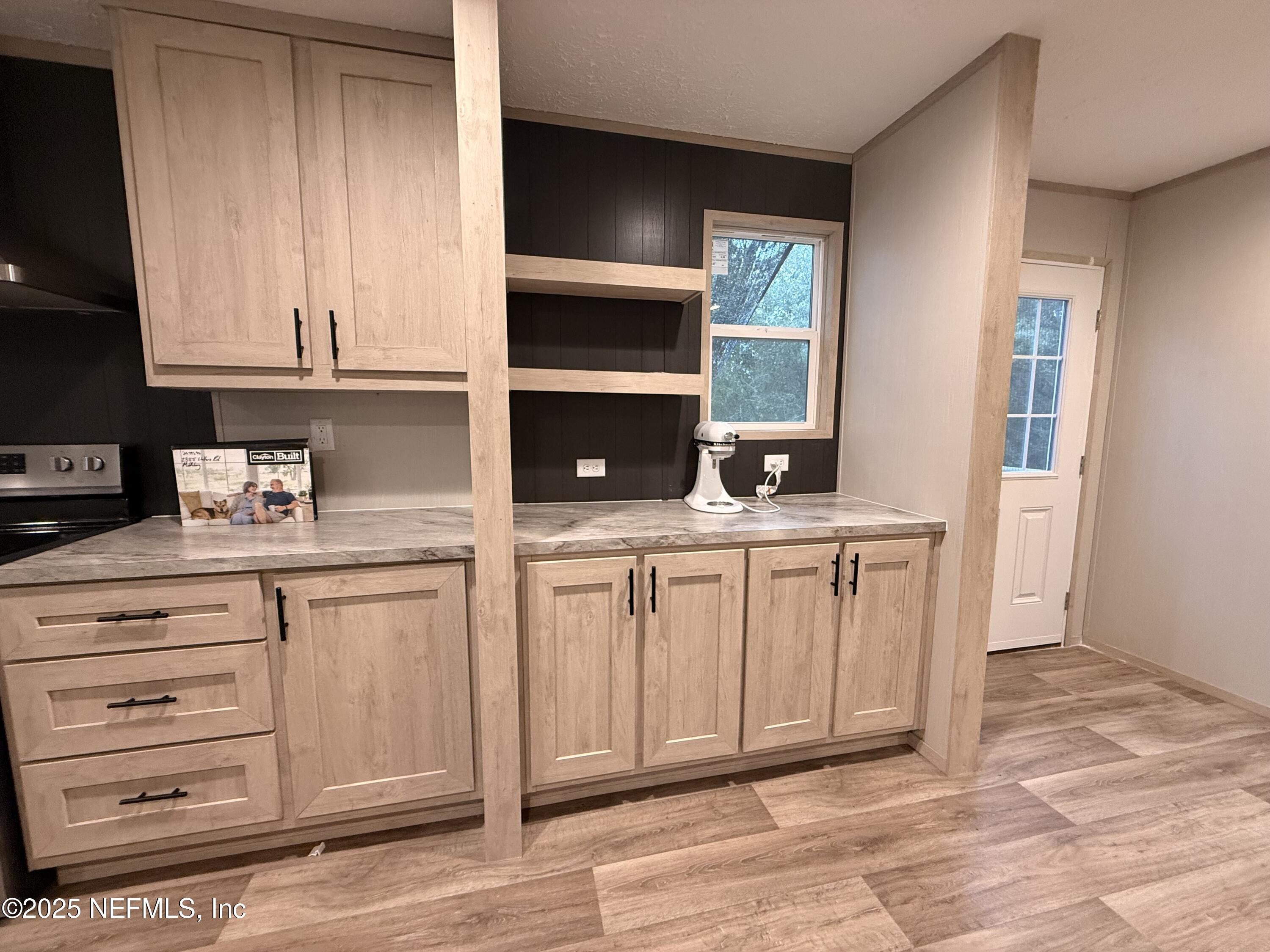 2355 Walters Road Middleburg, FL 32068 - Photo 9 of 63 a kitchen with white cabinets and window