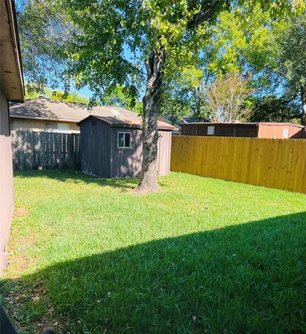 a view of a backyard with a garden and trees