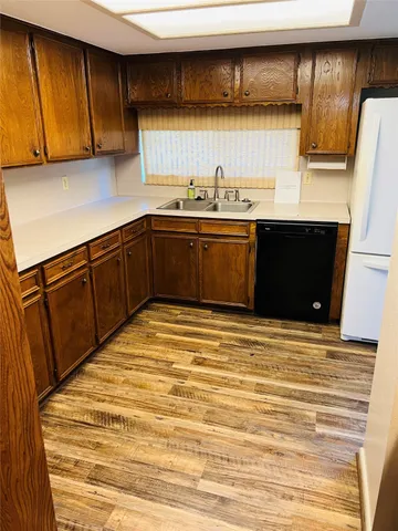 a kitchen with a cabinets and wooden floor