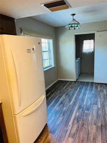 a view of livingroom with hardwood floor and kitchen