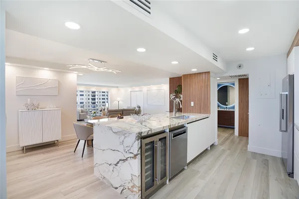 a kitchen with stainless steel appliances granite countertop a stove and a refrigerator