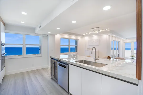 a kitchen with stainless steel appliances granite countertop a sink and a stove top oven