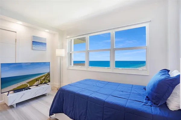 a bedroom with two beds and a flat screen tv