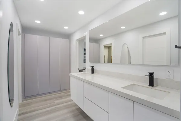 a large bedroom with a bed and a flat screen tv