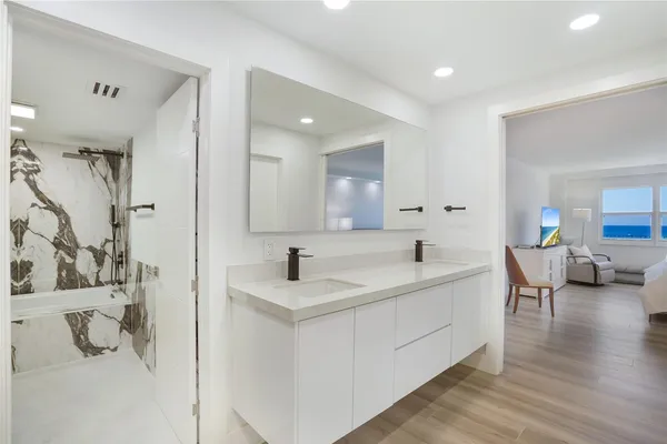 a bathroom with a bathtub sink and shower